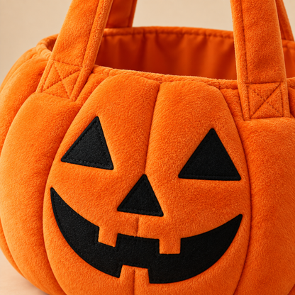 Close-up of pumpkin tote soft fabric stitching handles and jack-o-lantern face
